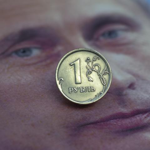 In this photo illustration, a one ruble coin on a portrait of Russian President Vladimir Putin is seen on July 14, 2025 in Bonn, Germany. Sanctions against Russia have caused the ruble to lose value. The Russian economy is struggling with the consequences of the war, which is costing the country enormous sums. (Photo illustration by Ulrich Baumgarten via Getty Images)