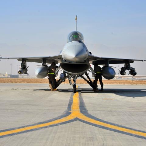 An F-16 pilot prepares for takeoff while airmen perform final preflight inspections on January 9, 2015, at Bagram Air Field in Afghanistan. (US Air Force)