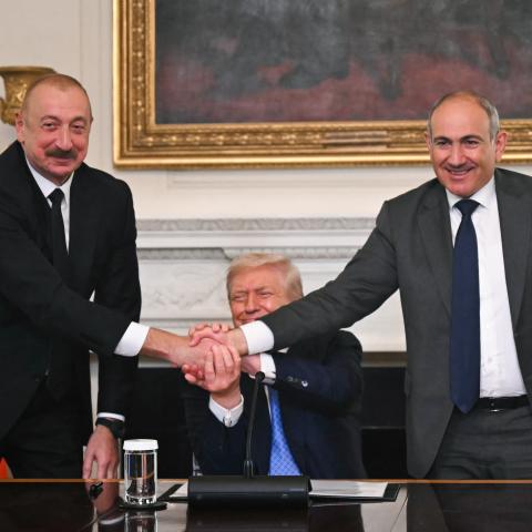 Azerbaijani President Ilham Aliyev, Armenian Prime Minister Nikol Pashinyan, and US President Donald Trump shake hands during a trilateral signing ceremony in the State Dining Room of the White House on August 8, 2025. (Getty Images)