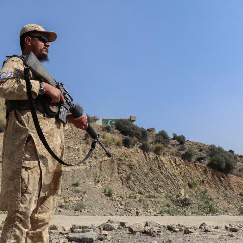  A Taliban security officer stands guard along a road near the Ghulam Khan border crossing between Afghanistan and Pakistan on October 20, 2025. (Getty Images)