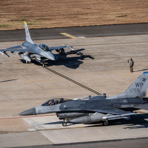 Two U.S. Air Force F-16 Fighting Falcons from the 35th Fighter Squadron prepare to taxi down the runway at Kunsan Air Base, Republic of Korea, Nov. 21, 2025. With the movement of 8th Fighter Wing’s F-16s from Kunsan AB to Osan AB during the Super Squadron Phase 2 test the 8th FW will continue to operate as a primary exercise and rotational force bed-down location for U.S. air component forces in the ROK. (U.S. Air Force photo by Tech. Sgt. Giovanni Sims)