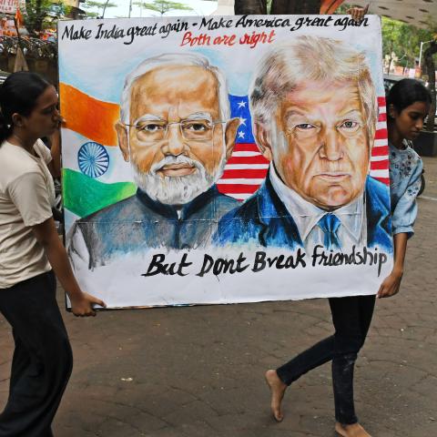 2025/08/01: Students from Gurukul School of Art carry a poster of Prime Minister of India Narendra Modi and U.S. President Donald Trump outside their school. U.S. President Donald Trump imposed a 25% tariff on India along with penalties for buying oil and military equipments from Russia. (Photo by Ashish Vaishnav/SOPA Images/LightRocket via Getty Images)