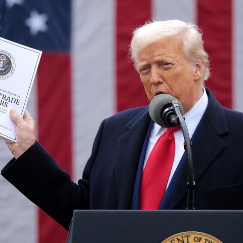  U.S. President Donald Trump holds up a copy of a 2025 National Trade Estimate Report as he speaks during a “Make America Wealthy Again” trade announcement event in the Rose Garden at the White House on April 2, 2025 in Washington, DC. Touting the event as “Liberation Day”, Trump is expected to announce additional tariffs targeting goods imported to the U.S. (Photo by Chip Somodevilla/Getty Images)
