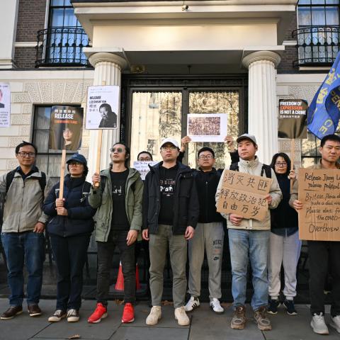 Protesters hold placards as they gather for a demonstration outside the Chinese Embassy in London on November 8, 2025. (Getty Images) Share to Twitter