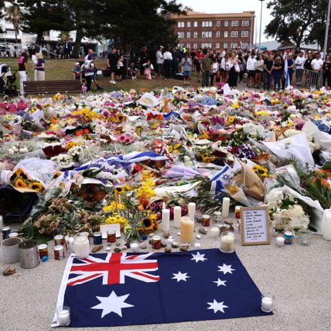 Mourners gather around floral tributes at Bondi Pavilion to honor the victims of the Bondi Beach shooting in Sydney, Australia, on December 16, 2025. (Getty Images)