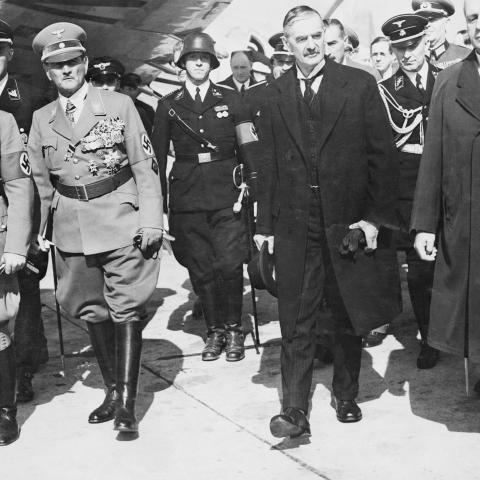 British Prime Minister Neville Chamberlain, German Foreign Minister Joachim von Ribbentrop, and General Franz von Epp leave the Munich Airport on September 30, 1938, for the Four Power Conference in Munich to decide the question of Czechoslovakia.