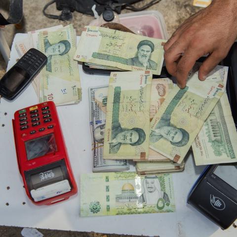 Stacks of Iranian rials and US dollars sit counted on a table in Tehran, Iran, on August 6, 2025. (Getty Images) Share to Twitter
