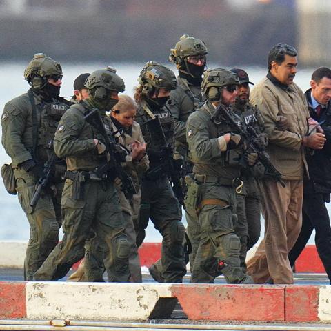 Nicolas Maduro and his wife, Cilia Flores, are seen in handcuffs after landing at a Manhattan helipad, escorted by heavily armed federal agents as they make their way into an armored car en route to a federal courthouse on January 5, 2026. (Getty Images)