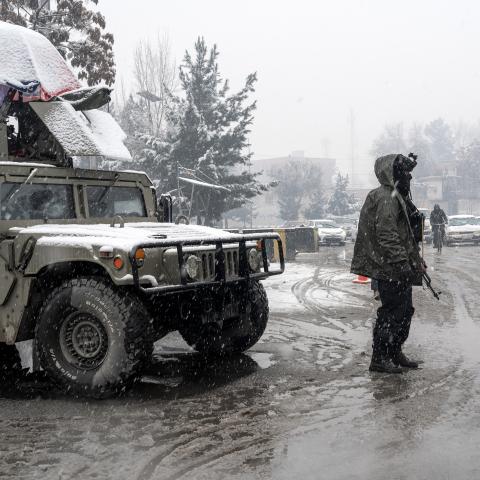 Taliban security personnel stand guard at a checkpoint during snowfall in Kabul on January 22, 2026. (Getty Images) Share to Twitter