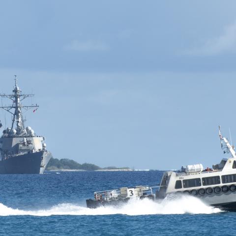 A tugboat crosses in front of the Arleigh Burke-class guided-missile destroyer USS Stethem as the ship arrives in Diego Garcia on January 3, 2024. (US Navy)