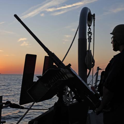 A US Navy fire controlman on the Arleigh Burke–class guided-missile destroyer USS Roosevelt stands on lookout in the Arabian Sea on December 8, 2025. (US Navy)