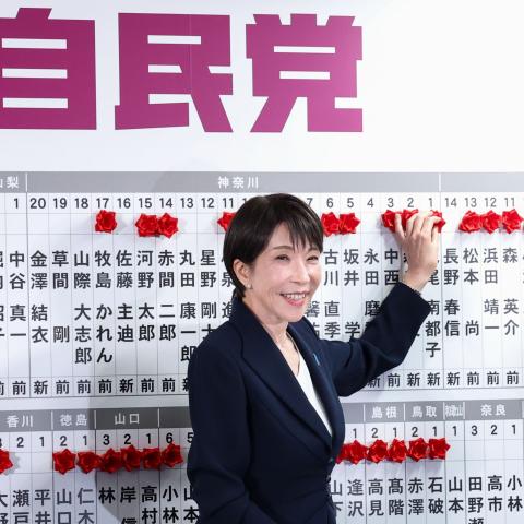 : Japan's Prime Minister Sanae Takaichi, leader of the ruling Liberal Democratic Party (LDP), places a red paper rose on the name of an elected candidate at the LDP headquarters on general election day on February 08, 2026 in Tokyo, Japan. Voters across the country headed to polls today as Japan's Lower House election was held. (Photo by Kim Kyung-Hoon - Pool/Getty Images)