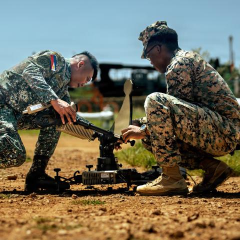 Philippine Marine Corps Staff Sgt. Lhardnernomer Sales, left, the communications noncommissioned officer in charge of 4th Marine Brigade, and U.S. Marine Corps Cpl. Donya Grady, a satellite transmissions operator assigned to Marine Rotational Force-Southeast Asia, I Marine Expeditionary Unit, set up a Viasat Multi-Mission Terminal during a staff exercise at Marine Base Camp Cape Bojeador, Philippines, Oct. 7, 2025. The MMT provides MRF-SEA with secure, high-bandwidth satellite communications for real-time d