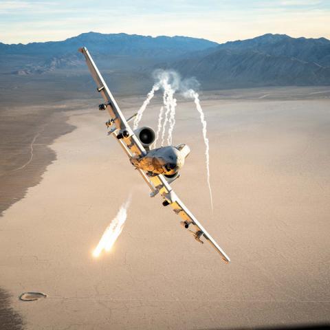 An A-10 Thunderbolt II assigned to the 66th Weapons Squadron, out of Nellis Air Force Base, deploys defensive flares during an evasive maneuver over a training range while escorting a C-130H assigned to the 152nd Airlift Wing, Nevada Air National Guard, Nevada, Feb. 26, 2026. The Flares are used to counter heat-seeking threats by diverting incoming missiles away from the aircraft. (U.S. Air Force photo by Tech. Sgt. Albert Valladares)