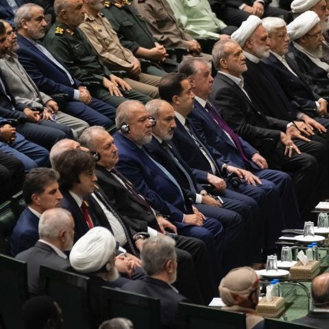 Iranian President Masoud Pezeshkian sits beside Iranian officials and other leaders during his swearing-in ceremony in Tehran on July 30, 2024. On the first row, second to the left, is Georgian Prime Minister Irakli Kobakhidze. (Getty Images)