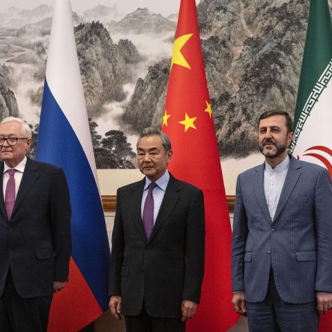 Caption China’s Foreign Minister Wang Yi welcomes Russia's Deputy Foreign Minister Sergey Ryabkov and Iran’s Deputy Foreign Minister Kazeem Gharibabadi at the Diaoyutai State Guesthouse in Beijing on March 14, 2025. (Getty Images)