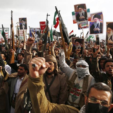 Pro-Iran protesters brandish billboards depicting the Iranian Supreme Leader Ali Hosseini Khamenei, flags of Yemen and Iran, weapons, and chant slogans as they take part in a rally on March 1, 2026, in Sana'a, Yemen. (Getty Images) Share to Twitter