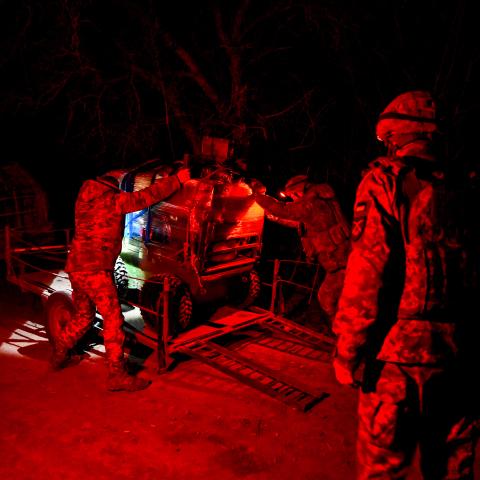 Fighters of the unmanned and ground robotic systems unit onto a platform for transport to a deployment point in Ukraine on March 10, 2026. (Getty Images)