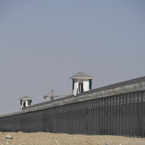 This photo taken on May 31, 2019 shows watchtowers on a high-security facility near what is believed to be a re-education camp where mostly Muslim ethnic minorities are detained, on the outskirts of Hotan, in China's northwestern Xinjiang region. - As many as one million ethnic Uighurs and other mostly Muslim minorities are believed to be held in a network of internment camps in Xinjiang, but China has not given any figures and describes the facilities as "vocational education centres" aimed at steering peo
