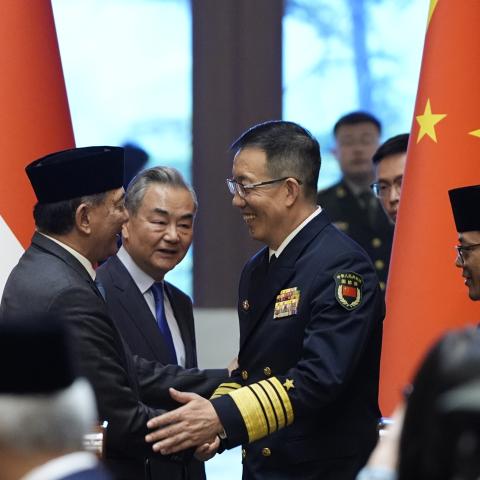Indonesian Defense Minister Sjafrie Sjamsoeddin(L) and Chinese Defense Minister Dong Jun (3rd L) shake hands as Chinese Foreign Minister Wang Yi (2nd L) and Indonesian Foreign Minister Sugiono(R) look on after a press briefing after the first meeting of China-Indonesia joint foreign and defense ministerial dialogue at the Diaoyutai State Guest House on April 21, 2025 in Beijing, China. (Photo by Iori Sagisawa - Pool/Getty Images)