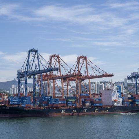 Rusty KMTC Line ship and commercial port cranes loading containers onto a container ship in Busan Port, Korea on July 31, 2025. Illustration of global shipping. (Photo by Antoine Boureau / Hans Lucas via AFP) (Photo by ANTOINE BOUREAU/Hans Lucas/AFP via Getty Images)