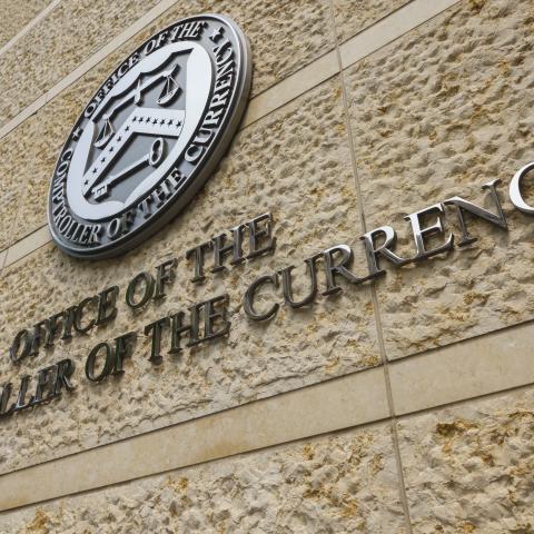 A sign is displayed at the Office of the Comptroller of the Currency (OCC) headquarters on June 1, 2025, in Washington, DC. (Getty Images)