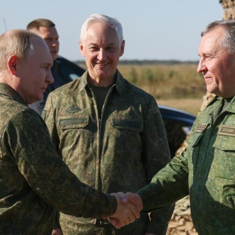Russian President Vladimir Putin shakes hands with Belarusian Defence Minister Viktor Khrenin at a training ground in the Nizhny Novgorod Oblast on September 16, 2025. (Getty Images