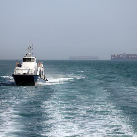 An Iran-flagged passenger vessel Atlas Pishro cruises near ships anchored in the Strait of Hormuz on May 2, 2026. (Getty Images)