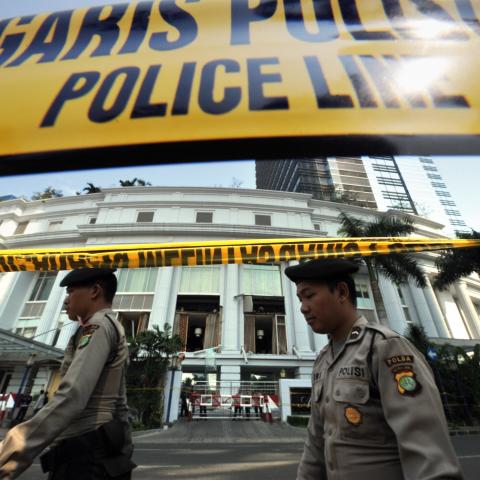 Policemen walk past the Ritz-Carlton hotel in Jakarta on July 20, 2009, after a blast tore through the hotel. (Getty Images)