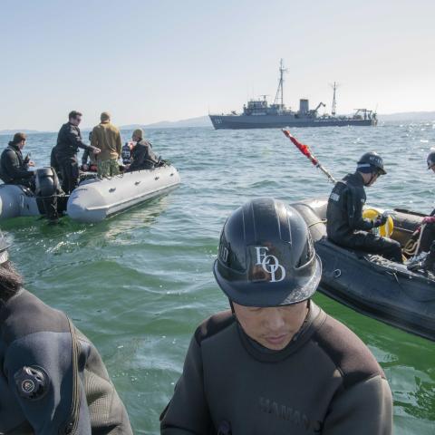 Sailors from the US Navy Explosive Ordnance Disposal Mobile Unit 1 and the Japan Maritime Self-Defense Force prepare for a mine-sweep exercise dive using an unmanned underwater vehicle to detect training mines in Japan’s Ise Bay on February 4, 2020. (US Air Force)