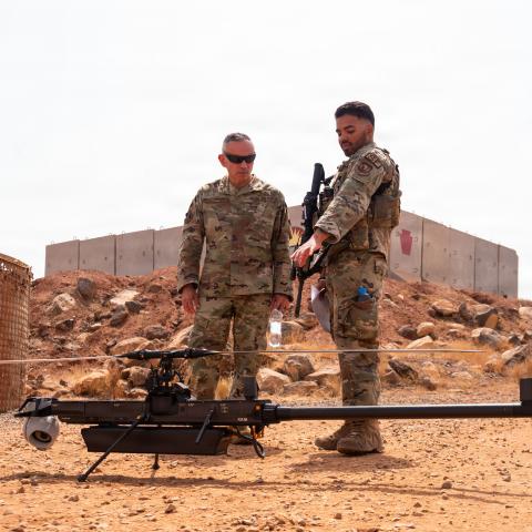 U.S. Air Force Col. Valentin Maldonado, 406th Air Expeditionary Wing deputy commander, left, is shown a small unmanned aerial system by Senior Airman Luis Oriz-Ortiz, 776th Expeditionary Air Base Squadron security forces member, right, at Chabelley Airfield, Djibouti, May 20, 2026. Maldonado's visit reinforced the importance of mission readiness, force development and supporting personnel operating in a dynamic expeditionary environment. (U.S. Air Force photo by Senior Airman Luis Gomez) Read less