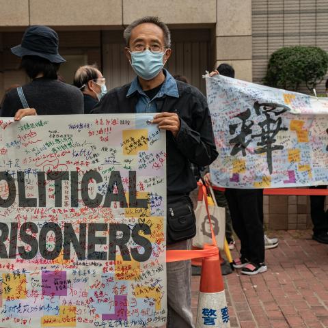 Pro-democracy activists line up outside the West Kowloon court as they hold a banner that reads, “Release all political prisoners,” on March 1, 2021, in Hong Kong, China. (Getty Images)
