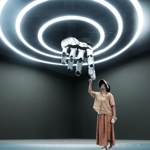 A visitor interacts with a mechanical hand at the Robot Mall on August 4, 2025, in Beijing. (Getty Images)