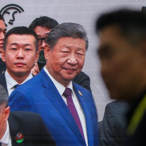 Chinese President Xi Jinping is seen greeting world leaders on a broadcast screen during the APEC Economic Leaders' Week, in Gyeongju, South Korea, on November 1, 2025. (Getty Images)
