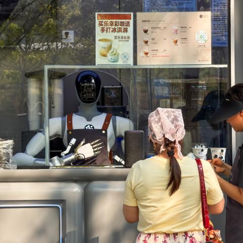 Customers place an order at a robot-operated coffee kiosk on March 25, 2026, in Shenzhen, China. (Getty Images)