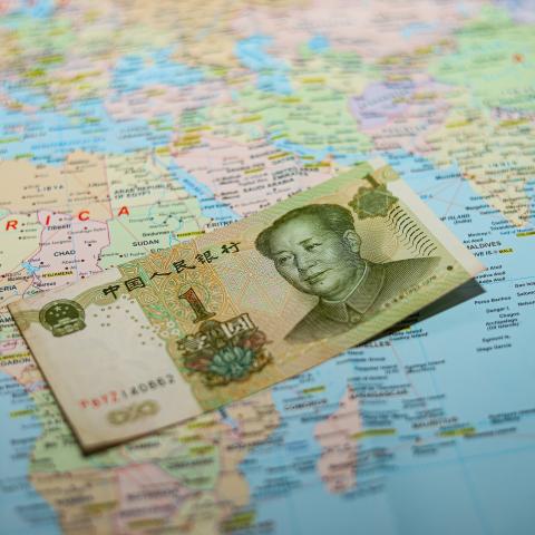 A Chinese yuan banknote on a world map in March 2026. (Getty Images