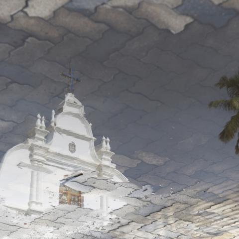 A church is reflected in a puddle following rain in Kochi, India, on May 22, 2026. (Getty Images)