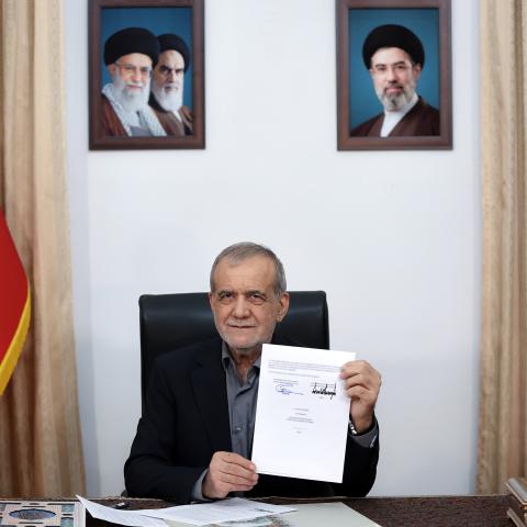 Iranian President Masoud Pezeshkian signs the memorandum of understanding at his office in Tehran, Iran, on June 18, 2026. (Iranian Presidency via Getty Images)