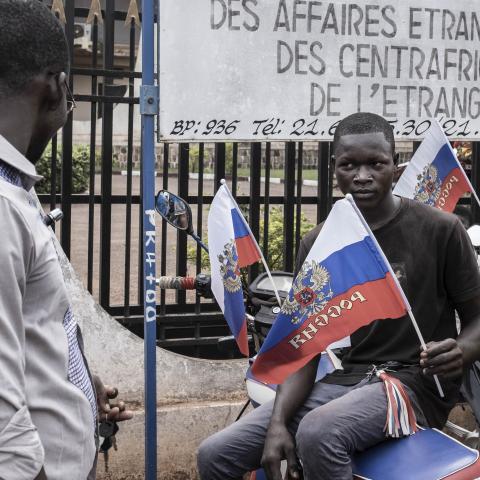 A demonstrator holds a flag with the emblem of Russia in Bangui, Central African Republic, on March 22, 2023, while sitting on a motorcycle during a march in support of Russia’s and China’s presence in the country. (Getty Images)