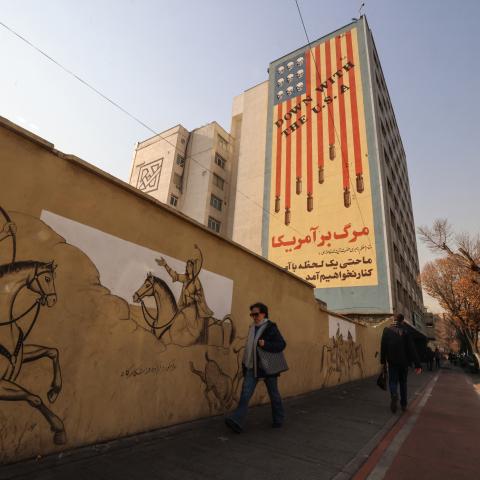 Iranians walk past an anti-US mural on a street in Tehran, on January 6, 2026. (Getty Images)