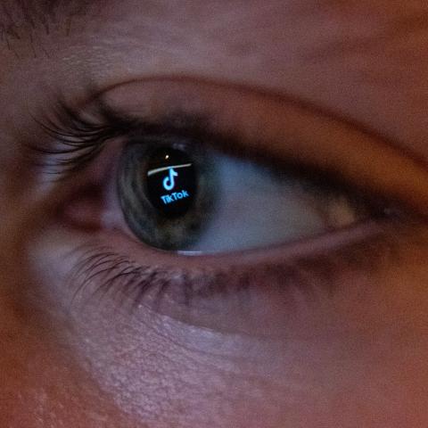 The TikTok social media platform's logo is reflected in the eye of a 13-year-old boy as he looks at a computer screen on November 25, 2023, in Bath, England. (Getty Images) Share to Twitter