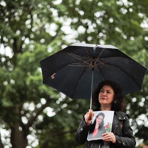 Rushan Abbas holds a photo of her sister, Uyghur doctor Gulshan Abbas, who is detained in China, during the “No Deals Without Freedom” protest at Lafayette Park on May 11, 2026, in Washington, DC. (Getty Images)