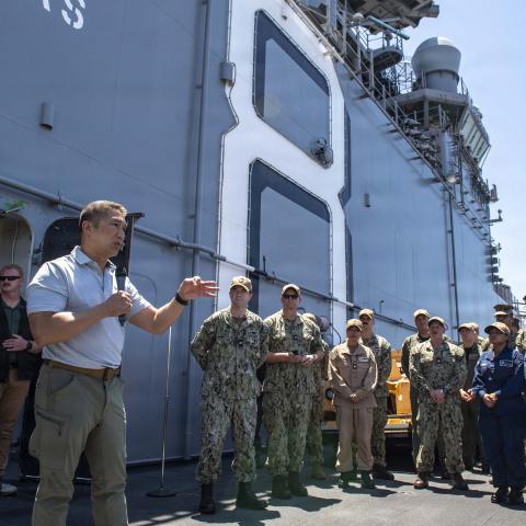 Acting Secretary of the Navy Hung Cao speaks to the crew of Wasp-class amphibious assault ship USS Makin Island during an all-hands call on the flight deck on August 7, 2026, in San Diego, California. (US Navy)