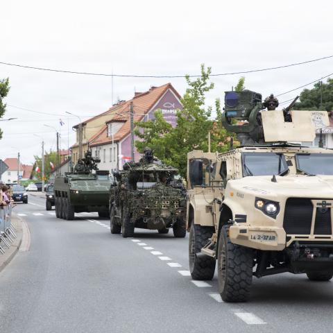 Military vehicles from the US Army, British Army’s Light Dragoons, and Romanian Armed Forces—which are all part of the NATO Forward Land Forces Battle Group-Poland—maneuver during a Polish Armed Forces Day parade in Orzysz, Poland, on August 16, 2026. (US Army Reserve)