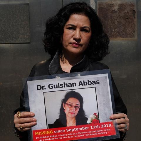 Campaign for Uyghurs Executive Director Rushan Abbas holds a photo of her sister, Gulshan Abbas, in New York on March 22, 2021. (Getty Images)