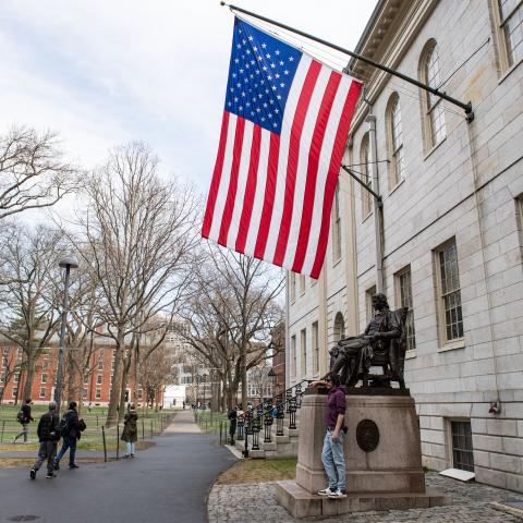 People gather around the John Harvard Statue on the Harvard University campus in Cambridge, Massachusetts, on April 15, 2025. (Getty Images)