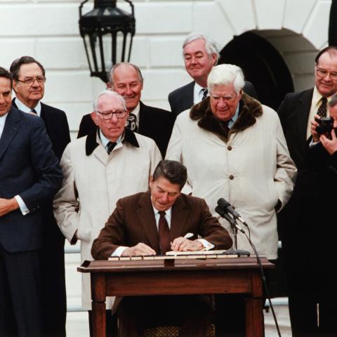 President Ronald Reagan signs the Social Security Act Amendment with Vice President George Bush, Senator Bob Dole, and Congressmen Tip O'Neill and Daniel Moynihan on hand as witnesses on April 20, 1983. (Getty Images)