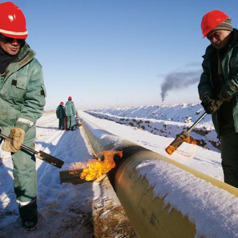 Kazakh oil workers lay an oil pipeline by the Canadian oil company Hurricane Kumkol Munai on December 19, 2002, north of Kyzylorda, Kazakhstan. (Getty Images)