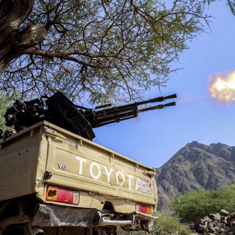 A fighter loyal to Yemen's internationally-recognised government fires a turret from the back of a pickup truck at a position along the frontlines against the Houthis around Mount al-Midan in Yemen's western Taiz province on October 26, 2026. The Saudi-led coalition fighting the Houthis has launched hundreds of raids in Yemen backing the internationally recognised government since the start of the renewed fighting in the long-running civil war. The conflict, dormant for years, erupted again in July and inte