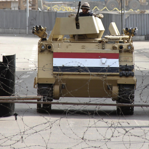 Egyptian soldiers are seen standing guard in military vehicles in Cairo's Tahrir square on January 26, 2014 the day after thousands of demonstrators protested in the square. (AHMED TARANH/AFP/Getty Images) 